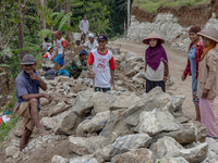 Villagers, including men and women, work together (gotong royong) to renovate a broken village road at Kebumen, Central Java, Indonesia on A...