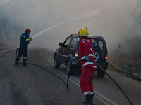 Firefighters operate near Prodromos village in Boeotia 100km north of Athens, Greece as a wildfire rages causing extensive damages to proper...