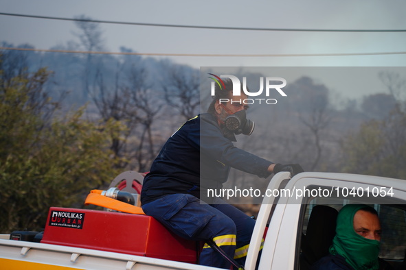 A fireman trying to extinguish the fire of the mountain Parnitha 22/8/23 