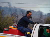 A fireman trying to extinguish the fire of the mountain Parnitha 22/8/23 (