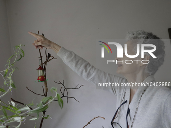 Catia Lattouf, health coucher, hummingbird rescuer and keeper, points to a hummingbird inside her apartment in Mexico City. (