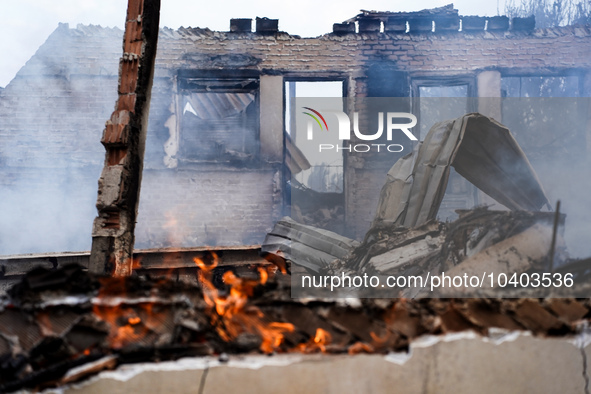 A flame is leaping from the wall of a fire-damaged house on Mount Parnitha in Athens, Greece, on  August 23, 2023 