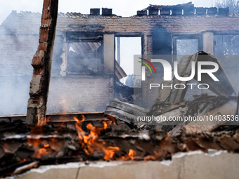 A flame is leaping from the wall of a fire-damaged house on Mount Parnitha in Athens, Greece, on  August 23, 2023 (