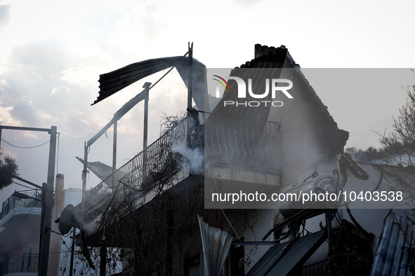 Damaged buildings from the wildfire on Mount Parnitha in Athens, Greece, are being photographed on  August 23, 2023 