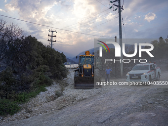 A bulldozer and a car from a private firefighting company are acting in the field of the fire on Mount Parnitha in Athens, Greece, on  Augus...