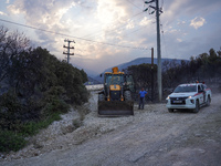 A bulldozer and a car from a private firefighting company are acting in the field of the fire on Mount Parnitha in Athens, Greece, on  Augus...