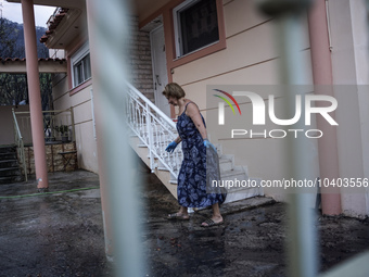 Residents of Mountain Parnitha, Greece, are trying to clean their yards of ash and coal on  August 23, 2023 (