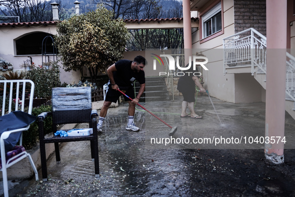 Residents of Mountain Parnitha, Greece, are trying to clean their yards of ash and coal on  August 23, 2023 