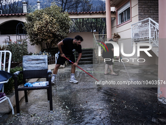 Residents of Mountain Parnitha, Greece, are trying to clean their yards of ash and coal on  August 23, 2023 (