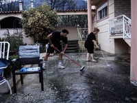 Residents of Mountain Parnitha, Greece, are trying to clean their yards of ash and coal on  August 23, 2023 (