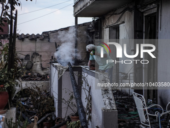 A resident is extinguishing the last flames from his house on Mount Parnitha in Athens, Greece, on August 23, 2023 (