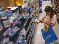 HANGZHOU, CHINA - AUGUST 24, 2023 - A substitute shopper helps an online customer buy salt at a supermarket in Hangzhou, Zhejiang province,...