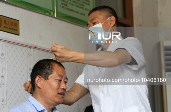 LINYI, CHINA - AUGUST 25, 2023 - A doctor performs balanced acupuncture for villagers in Linyi city, Shandong province, Aug 25, 2023. Throug...