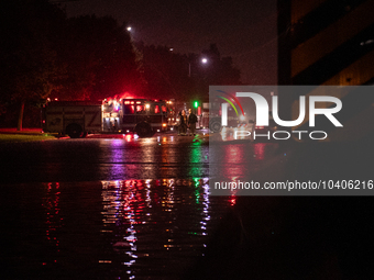 ROYAL OAK, MI - AUGUST 24, 2023: Firemen from the Royal Oak Fire Department blockade a flooded street after a severe thunderstorm that inclu...