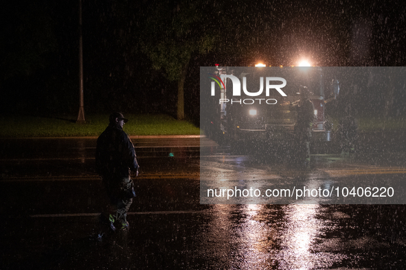 ROYAL OAK, MI - AUGUST 24, 2023: Firemen from the Royal Oak Fire Department blockade a flooded street after a severe thunderstorm that inclu...