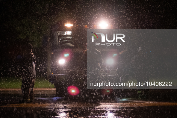 ROYAL OAK, MI - AUGUST 24, 2023: Firemen from the Royal Oak Fire Department blockade a flooded street after a severe thunderstorm that inclu...