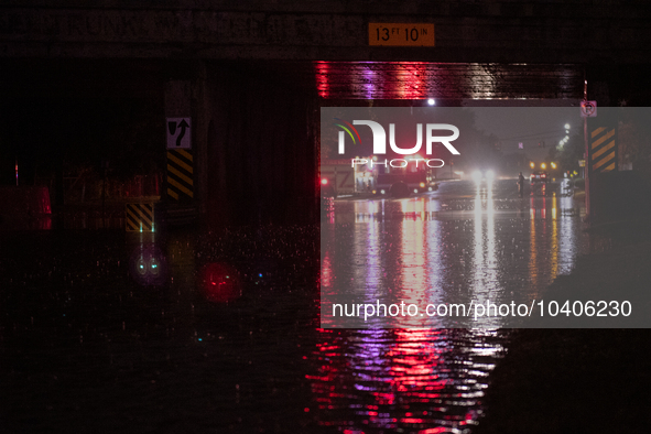 ROYAL OAK, MI - AUGUST 24, 2023: Firemen from the Royal Oak Fire Department blockade a flooded street after a severe thunderstorm that inclu...