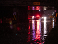 ROYAL OAK, MI - AUGUST 24, 2023: Firemen from the Royal Oak Fire Department blockade a flooded street after a severe thunderstorm that inclu...