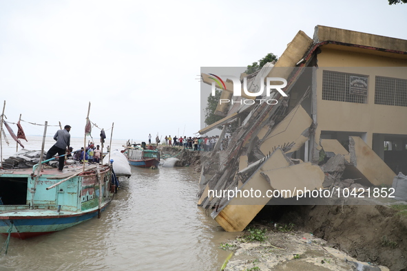 The image shows Mukundia Government Primary School collapse due to Padma river erosion on Tuesday night, August 24, 2023.  