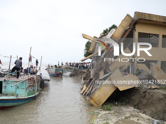 The image shows Mukundia Government Primary School collapse due to Padma river erosion on Tuesday night, August 24, 2023.  (