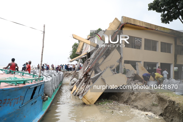 The image shows Mukundia Government Primary School collapse due to Padma river erosion on Tuesday night, August 24, 2023.  