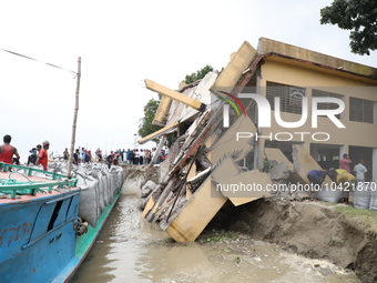 The image shows Mukundia Government Primary School collapse due to Padma river erosion on Tuesday night, August 24, 2023.  (