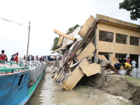 The image shows Mukundia Government Primary School collapse due to Padma river erosion on Tuesday night, August 24, 2023.  (