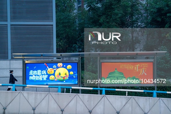 CHONGQING, CHINA - NOVEMBER 18, 2022 - (FILE) A citizen passes by a bus stop in Chongqing, China, November 18, 2022. With the rapid developm...