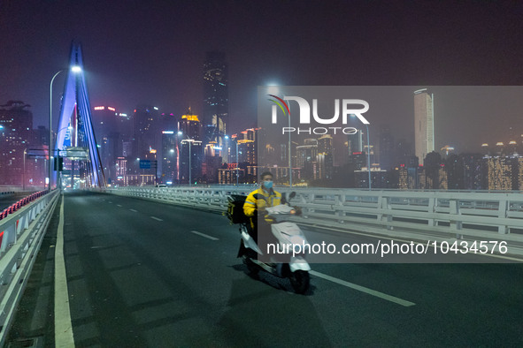 CHONGQING, CHINA - NOVEMBER 18, 2022 - (FILE) The picture shows a delivery man passing by Qiansimen Bridge. Chongqing, China, November 18, 2...