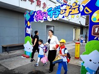 Children walk into a primary school in Beijing, China, September 1, 2023. On the same day, the new semester of primary and secondary schools...