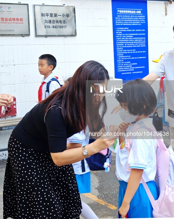 Children walk into a primary school in Beijing, China, September 1, 2023. On the same day, the new semester of primary and secondary schools...