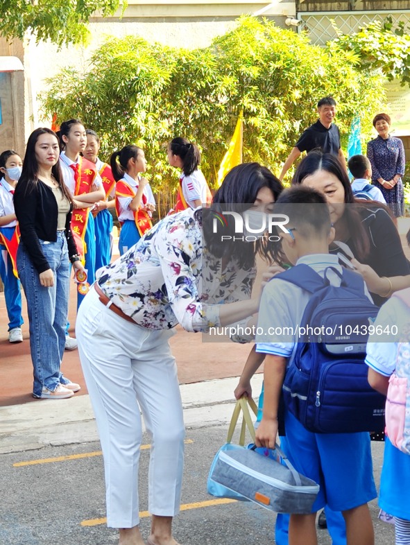 Children walk into a primary school in Beijing, China, September 1, 2023. On the same day, the new semester of primary and secondary schools...