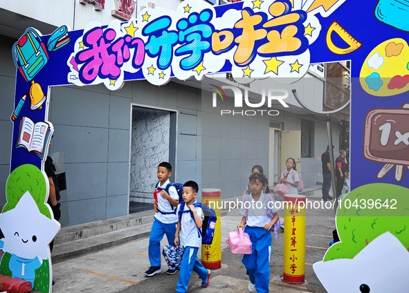 Children walk into a primary school in Beijing, China, September 1, 2023. On the same day, the new semester of primary and secondary schools...