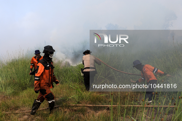 Firefighters from Regional Disaster Management Agency (BPBD) personnel and Indonesian Police Personnel from Ogan Ilir Regency are currently...