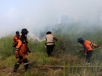 Firefighters from Regional Disaster Management Agency (BPBD) personnel and Indonesian Police Personnel from Ogan Ilir Regency are currently...