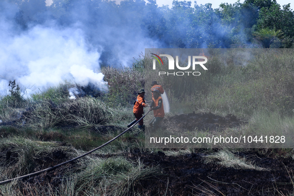 Firefighters from Regional Disaster Management Agency (BPBD) personnel and Indonesian Police Personnel from Ogan Ilir Regency are currently...