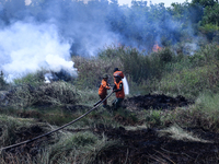 Firefighters from Regional Disaster Management Agency (BPBD) personnel and Indonesian Police Personnel from Ogan Ilir Regency are currently...