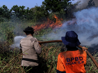 Firefighters from Regional Disaster Management Agency (BPBD) personnel and Indonesian Police Personnel from Ogan Ilir Regency are currently...