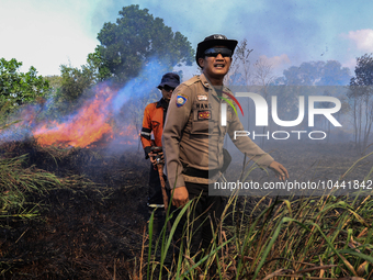 Firefighters from Regional Disaster Management Agency (BPBD) personnel and Indonesian Police Personnel from Ogan Ilir Regency are currently...