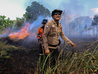 Firefighters from Regional Disaster Management Agency (BPBD) personnel and Indonesian Police Personnel from Ogan Ilir Regency are currently...