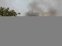 Heavy smoke from a large wildfire is seen rising from behind trees on September 2, 2023, near Huntsville in Walker County, Texas.  (