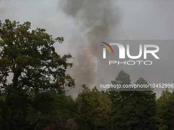 Heavy smoke from a large wildfire is seen rising from behind trees on September 2, 2023, near Huntsville in Walker County, Texas.  (