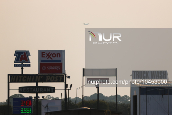 A firefighting aircraft is seen in the distance through the wildfire haze near Huntsville in Walker County, Texas.  