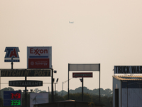 A firefighting aircraft is seen in the distance through the wildfire haze near Huntsville in Walker County, Texas.  (