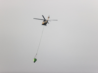 Helicopters help with the fire suppression effort during a large and fast-moving wildfire in Walker County, Texas on September 2, 2023.  (