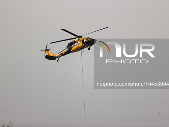 Helicopters help with the fire suppression effort during a large and fast-moving wildfire in Walker County, Texas on September 2, 2023.  (