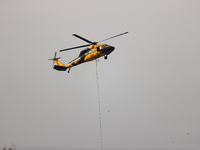 Helicopters help with the fire suppression effort during a large and fast-moving wildfire in Walker County, Texas on September 2, 2023.  (