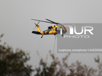 Helicopters help with the fire suppression effort during a large and fast-moving wildfire in Walker County, Texas on September 2, 2023.  (