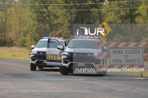 Police block local roads after mandatory evacuations have been ordered during a fast-moving wildfire in Walker County, Texas.  