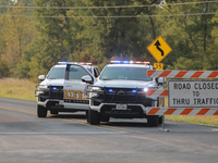 Police block local roads after mandatory evacuations have been ordered during a fast-moving wildfire in Walker County, Texas.  (